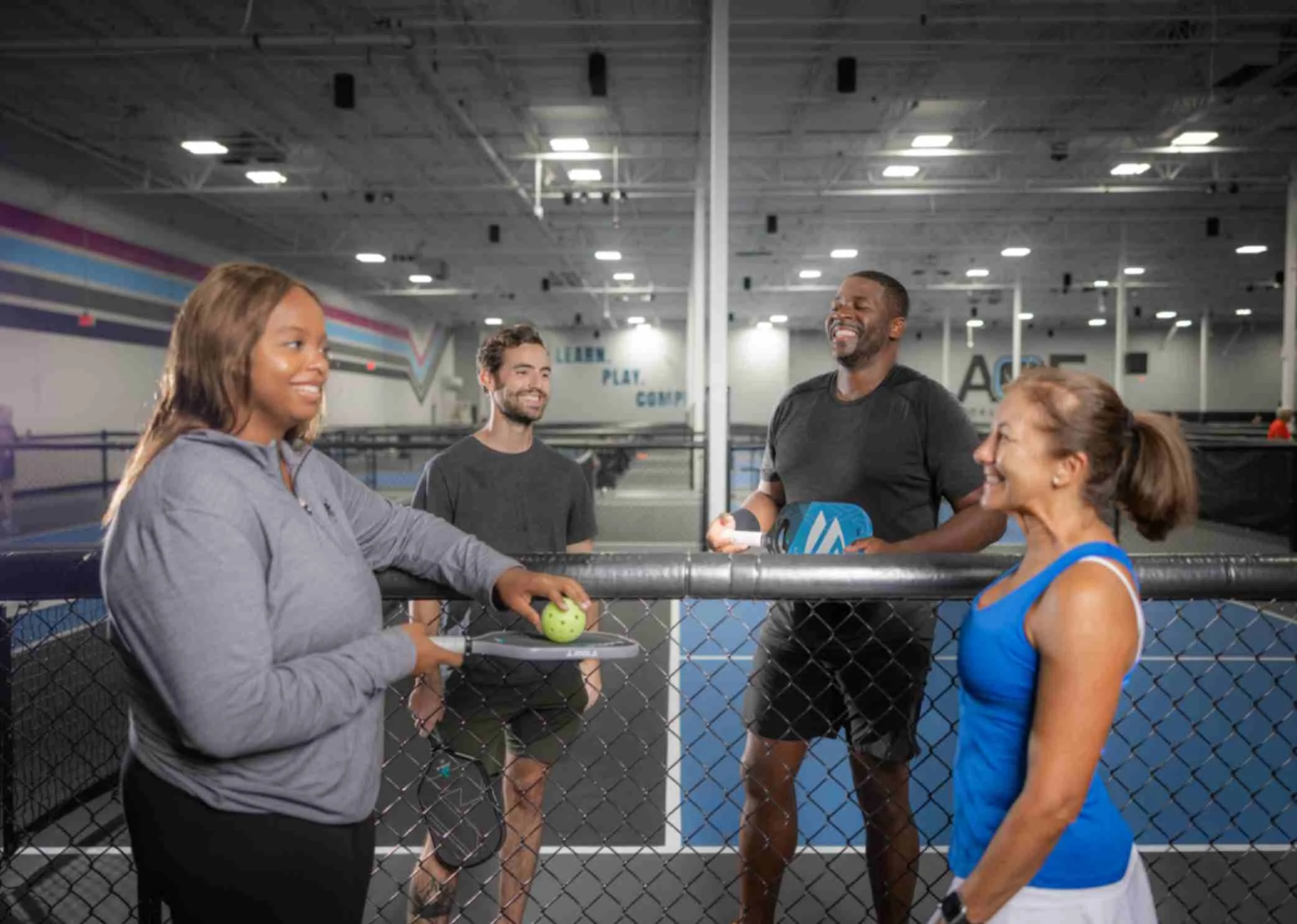 Four pickleball players chatting