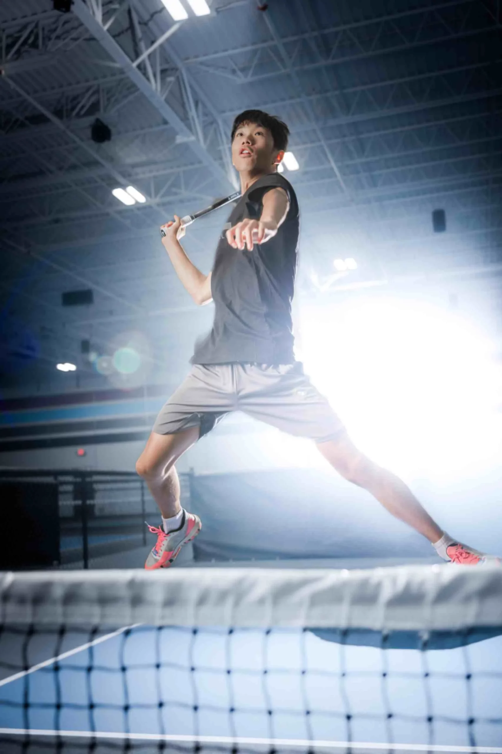 man jumps in the air to hit the ball